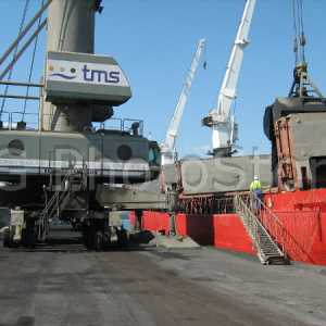 Mobile crane loading petroleum coke at the port of Valencia